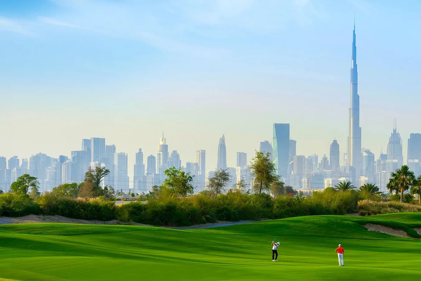 Dubai Hills golf course with the Burj Khalifa and city skyline on the horizon