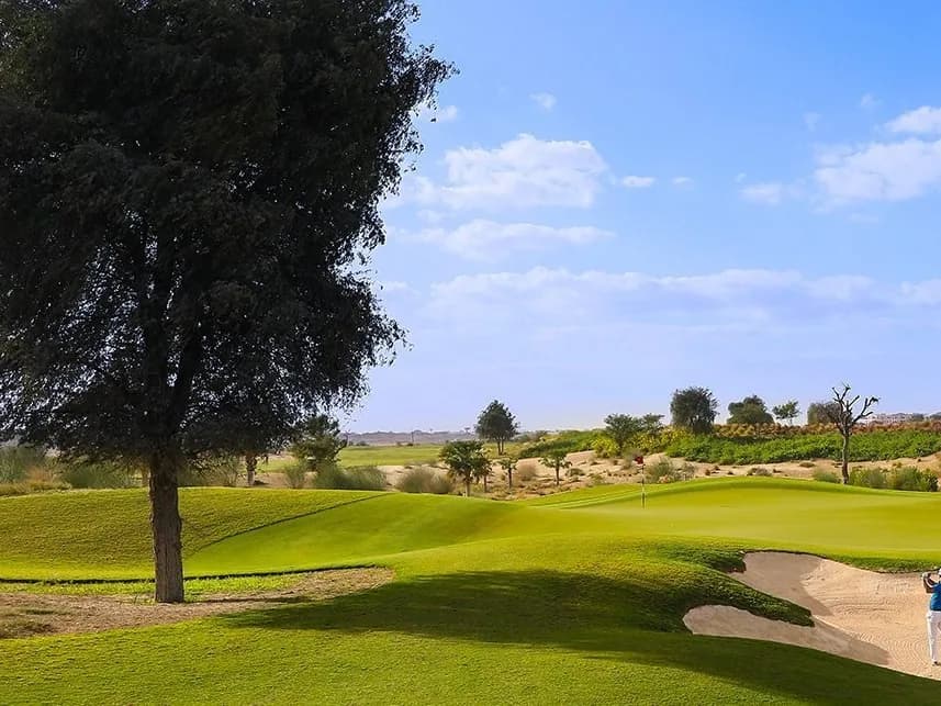 Golfer in a bunker on the Dubai Hills Golf Club course