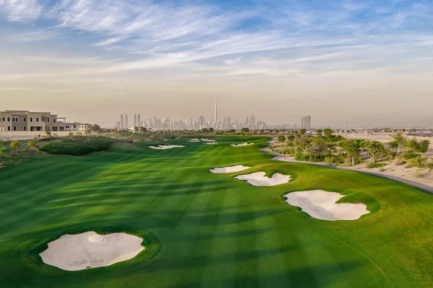 Dubai Hills Golf Club fairway with bunkers and the skyline in the distance