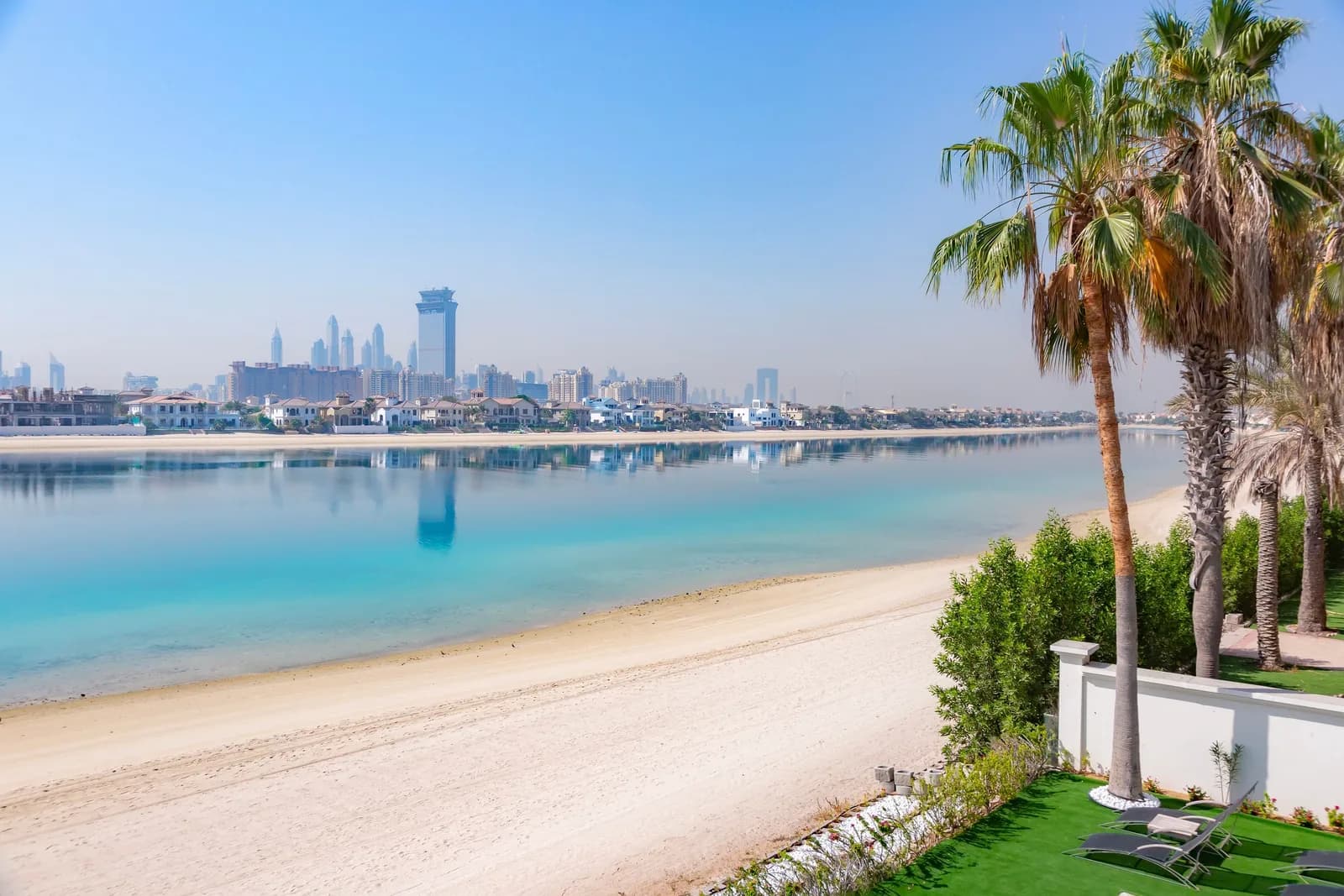 Palm Jumeirah beach with white sand and the Marina skyline across the water