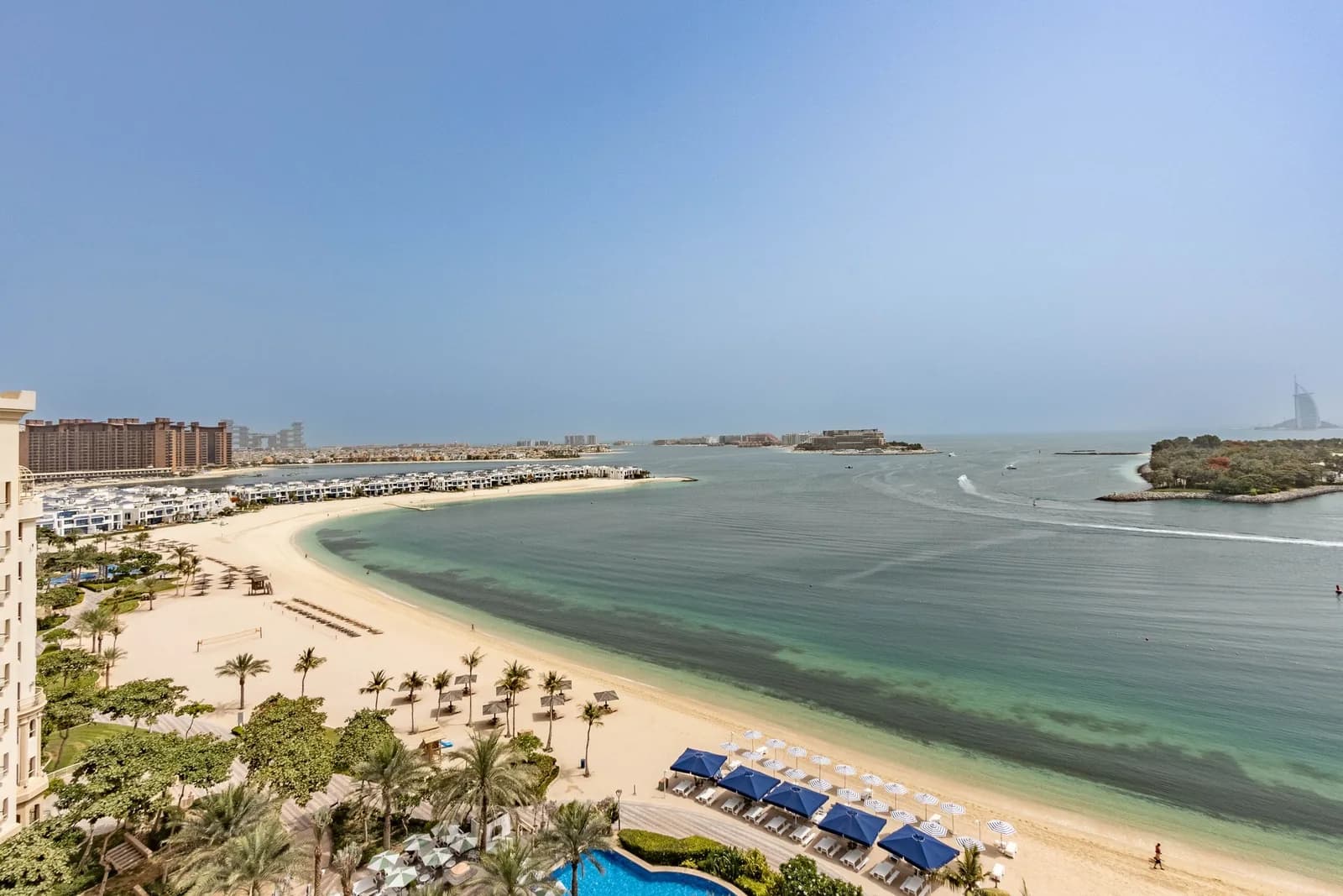 Aerial view of Palm Jumeirah's beach and the Dubai Marina towers