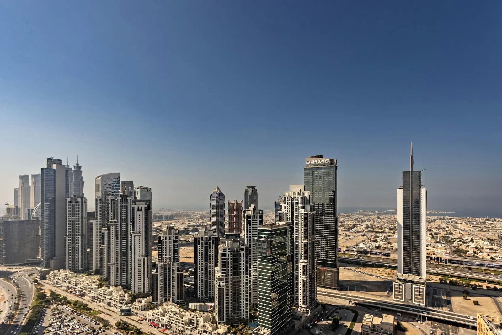 Business Bay towers rising against a clear blue sky