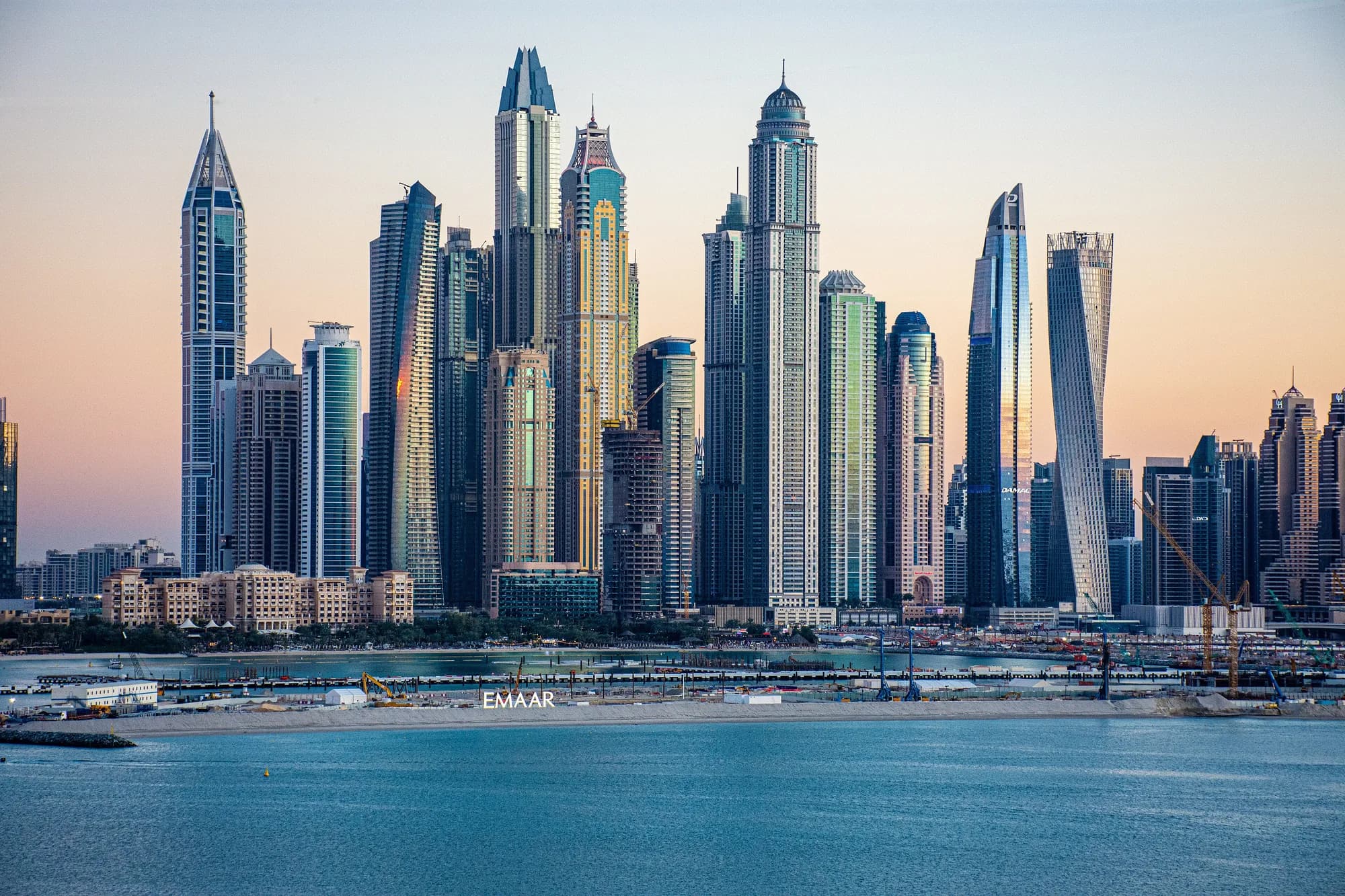 Dubai Marina skyline at dusk with Cayan Tower on the right