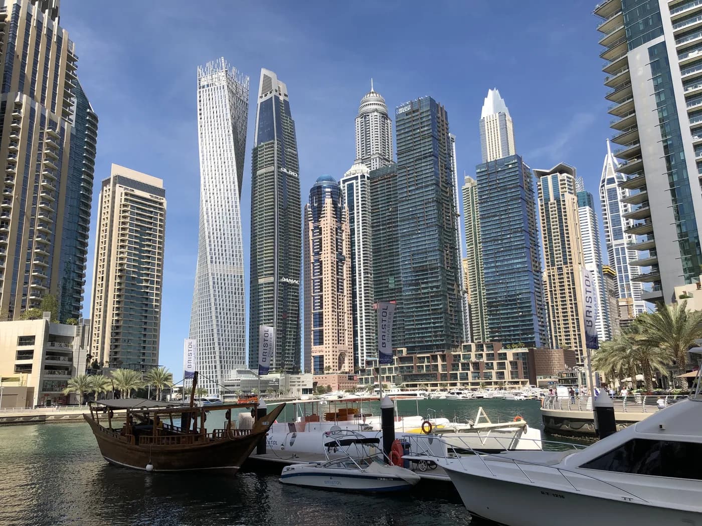 The twisted Cayan Tower rising above Dubai Marina with yachts below