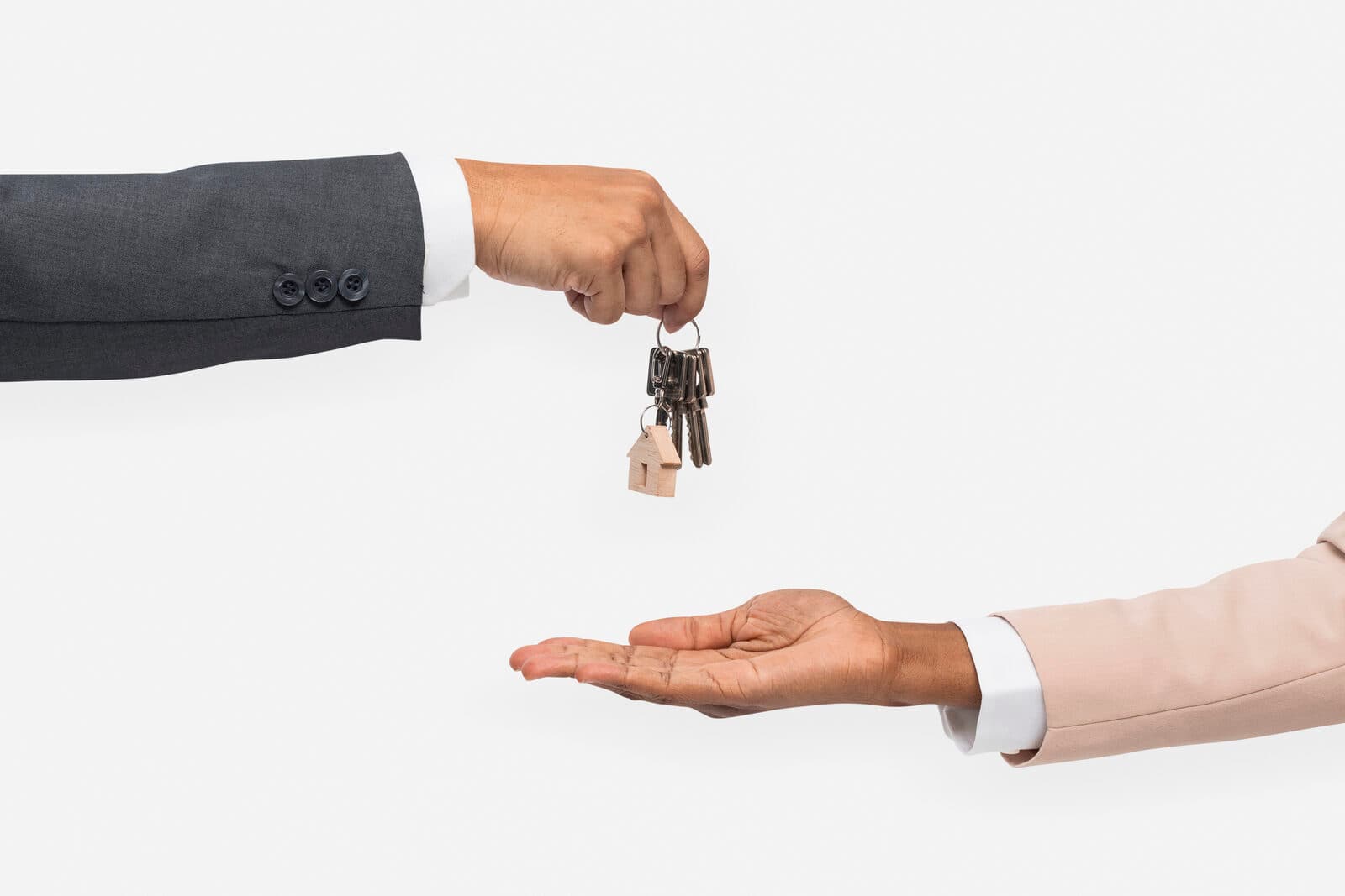 A real estate agent handing over a set of keys to a new tenant
